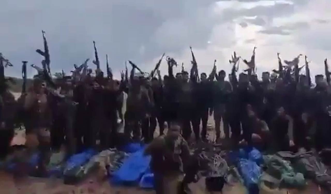 DRG forces celebrate in front of bodies of slain Maoists